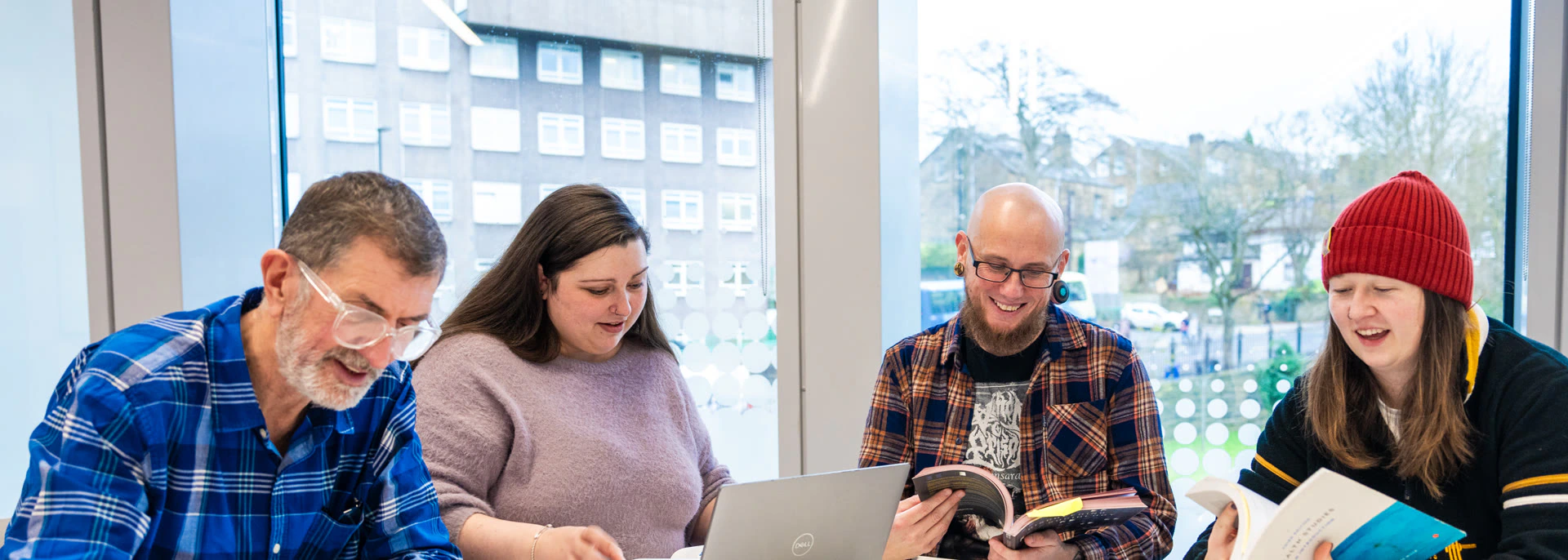 Four university learners studying together around a table